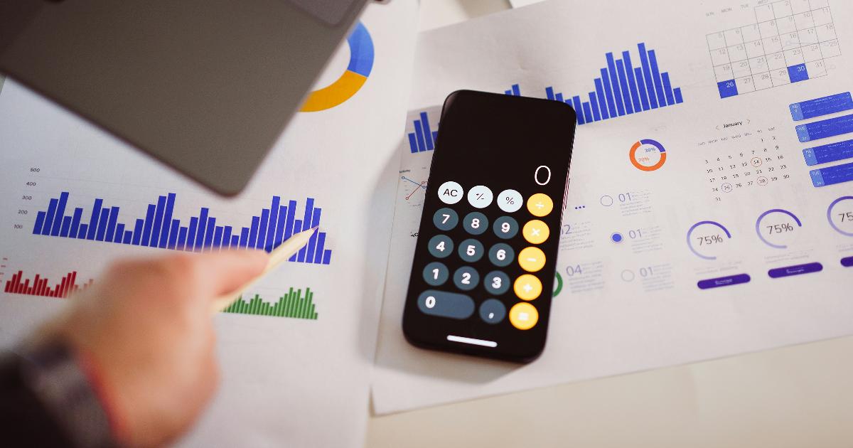A person reviewing bank statements and budget categories, illustrating a data-driven budget based on real spending data