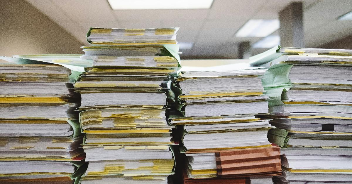 Employee reviewing IPO stock holdings and tax paperwork to assess the IPO windfall and diversification risk
