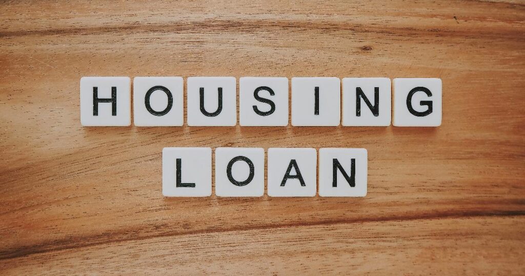A homebuyer reviewing a mortgage rate quote and loan estimate beside housing market charts