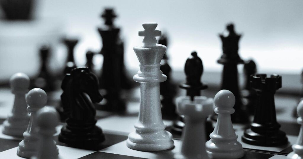 A portfolio dashboard beside a chessboard, illustrating hidden momentum exposure inside a diversified portfolio